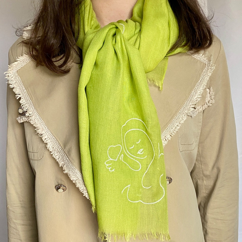 Muze green lightweight scarf in modal and silk on model displaying embroidery of muze love and heart original artistic drawing