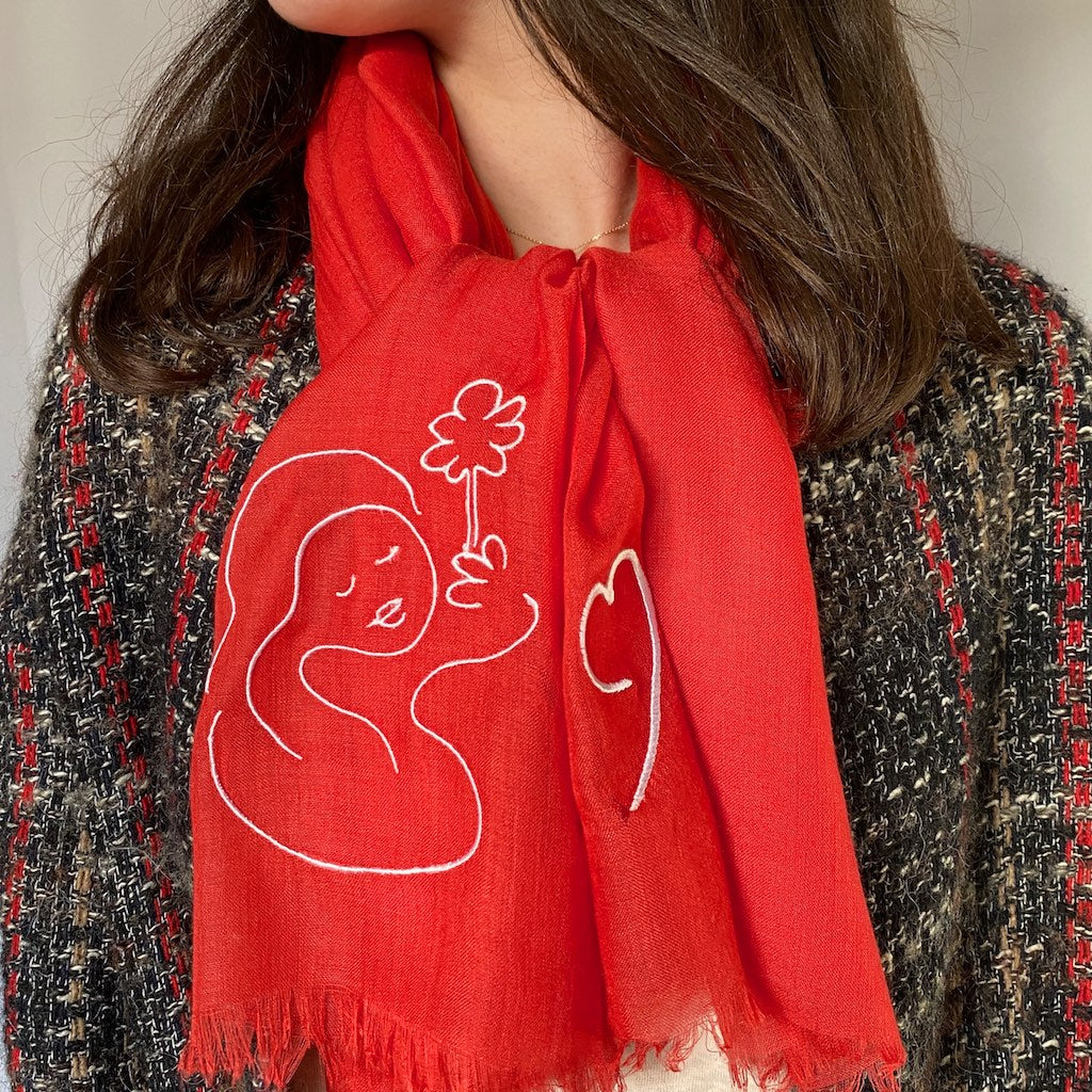 Muze red lightweight scarf in modal and silk on model displaying embroidery of a heart and muze peace original artistic drawing